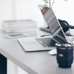 Computer, books, and cellphone on a desk